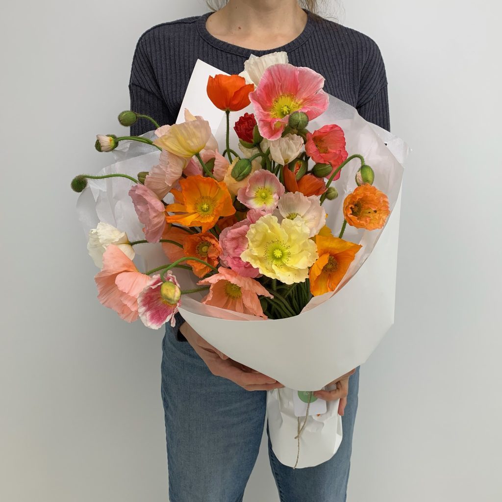 Bright mixed poppy bouquet in yellow, peach, orange and white with delicate petals