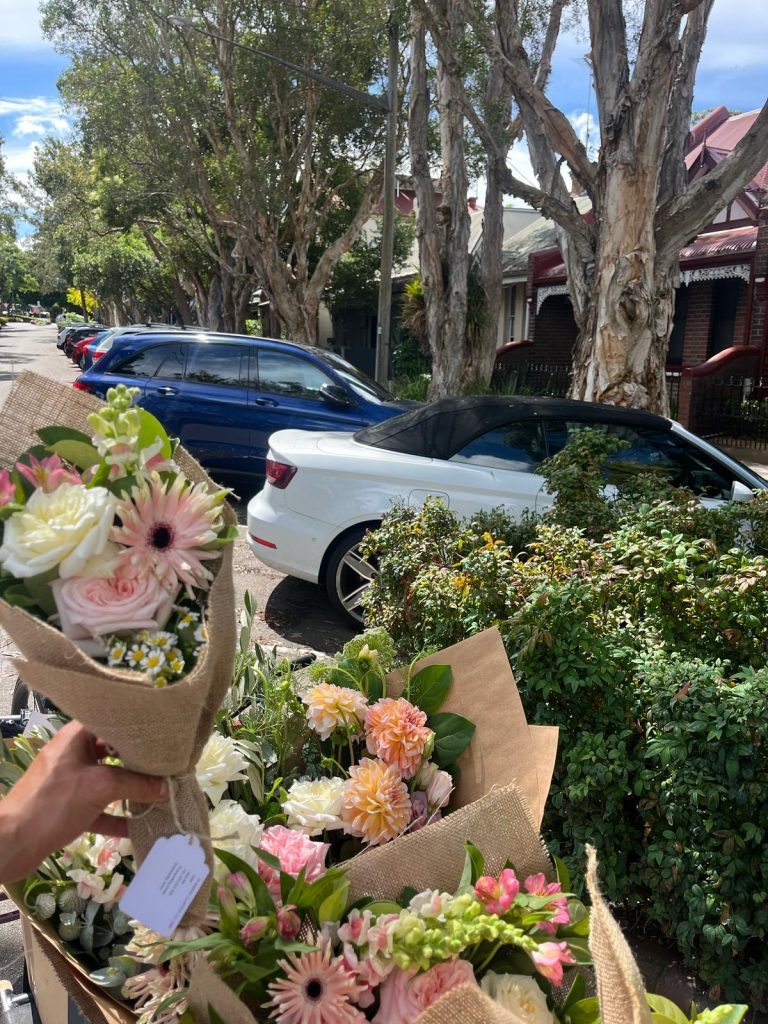 Sydney bike courier delivering Daily Mixed Bouquet with bunches in basket.
