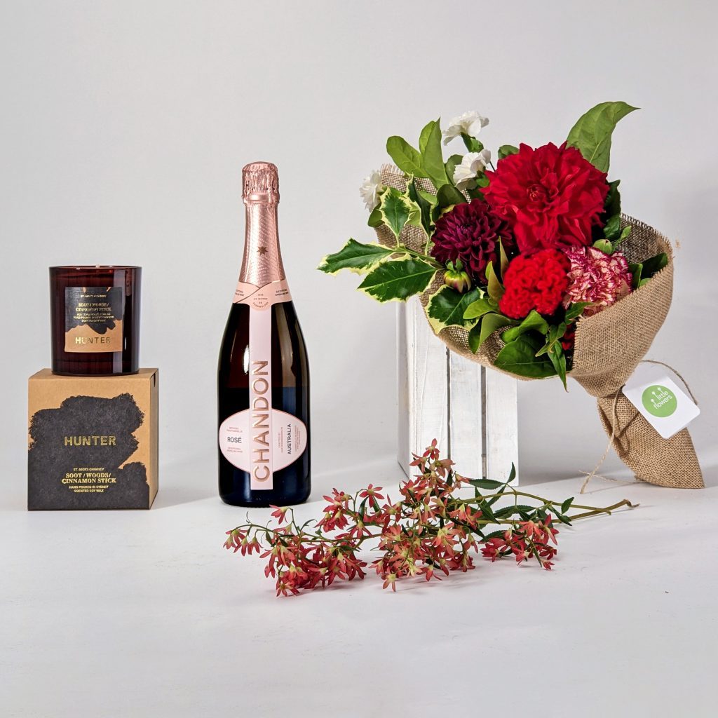 Christmas gift pack with candle, bubbles and flowers