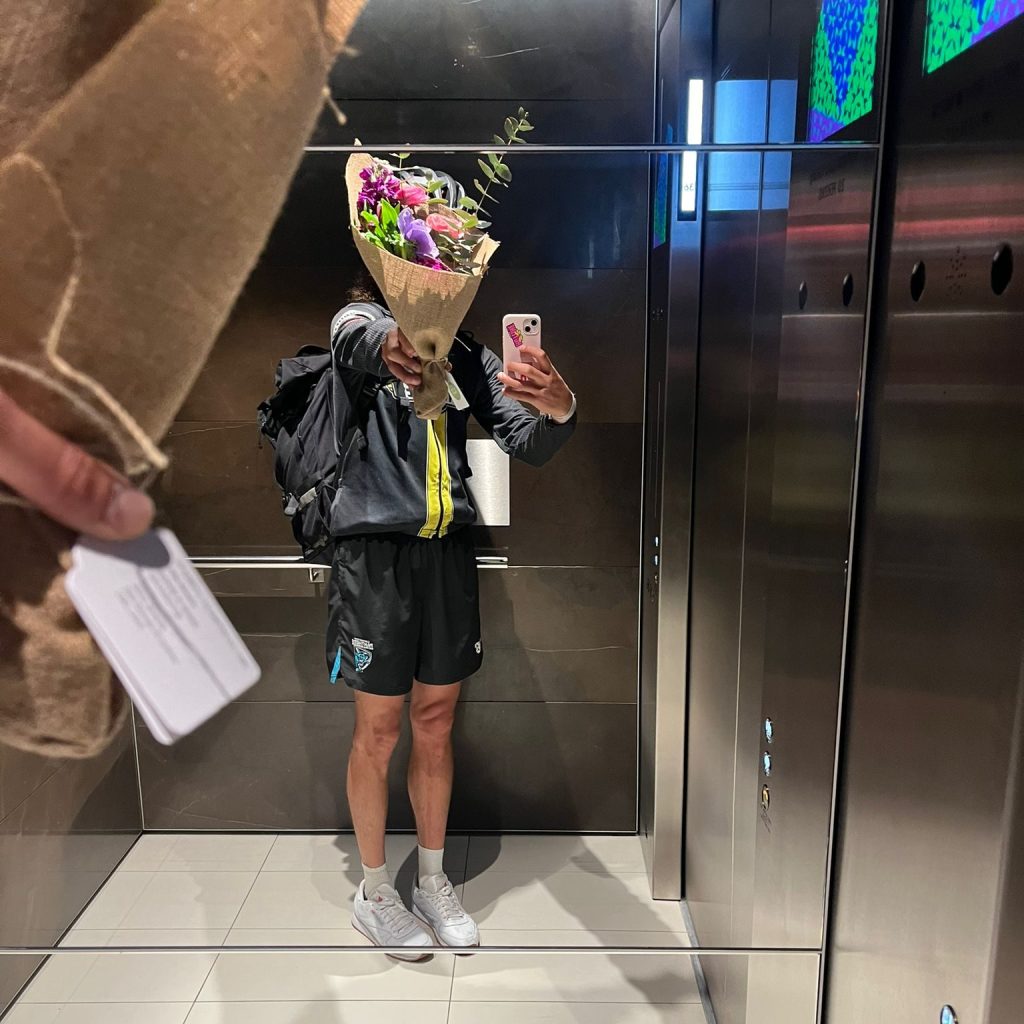 Courier carrying a bouquet into a Sydney office lift