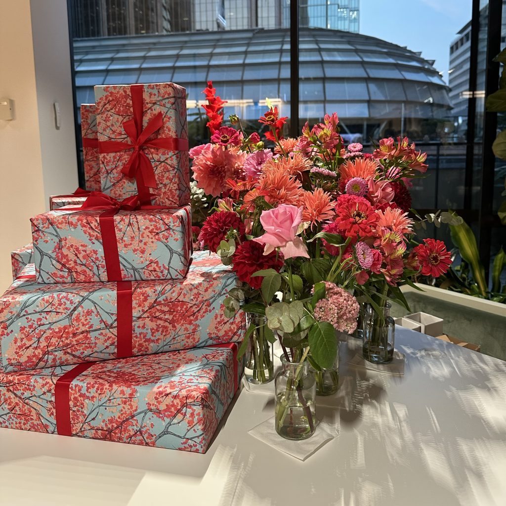 Pink and red floral vases styled with matching presents