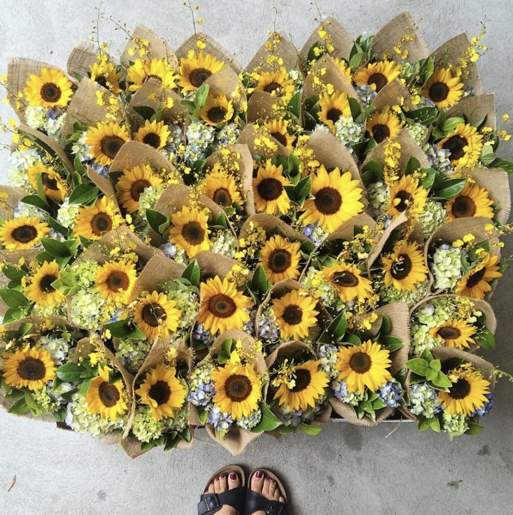 Overhead view of mixed bouquets with sunflowers ready for dispatch