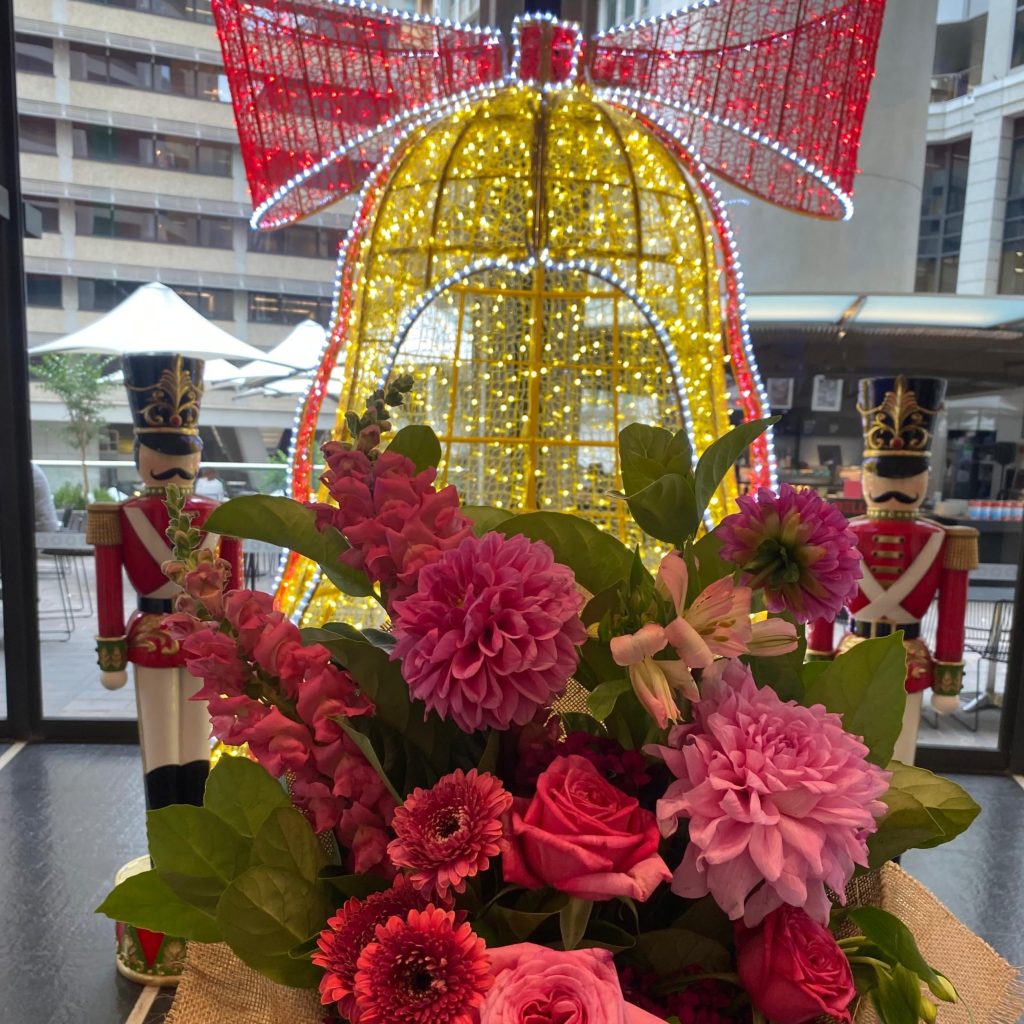 Christmas bouquet in the Sydney CBD with festive decorations in the background