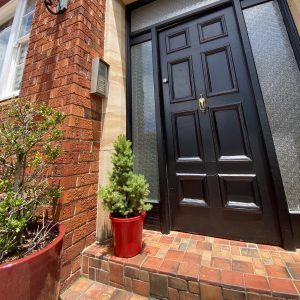 Potted Christmas tree placed outside a Sydney home ready for collection and replanting