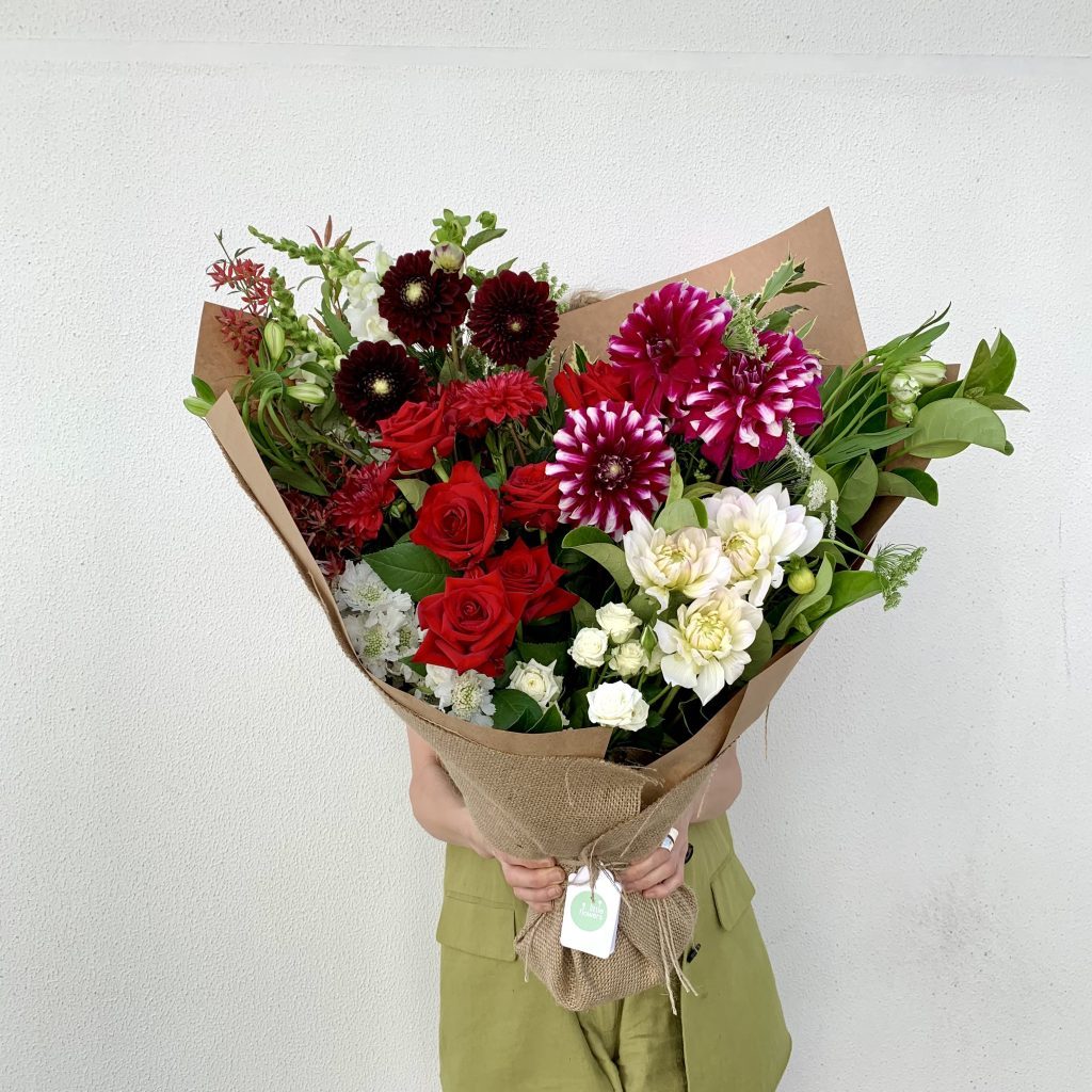 Luxe Christmas bouquet in festive colours arranged by Little Flowers Sydney