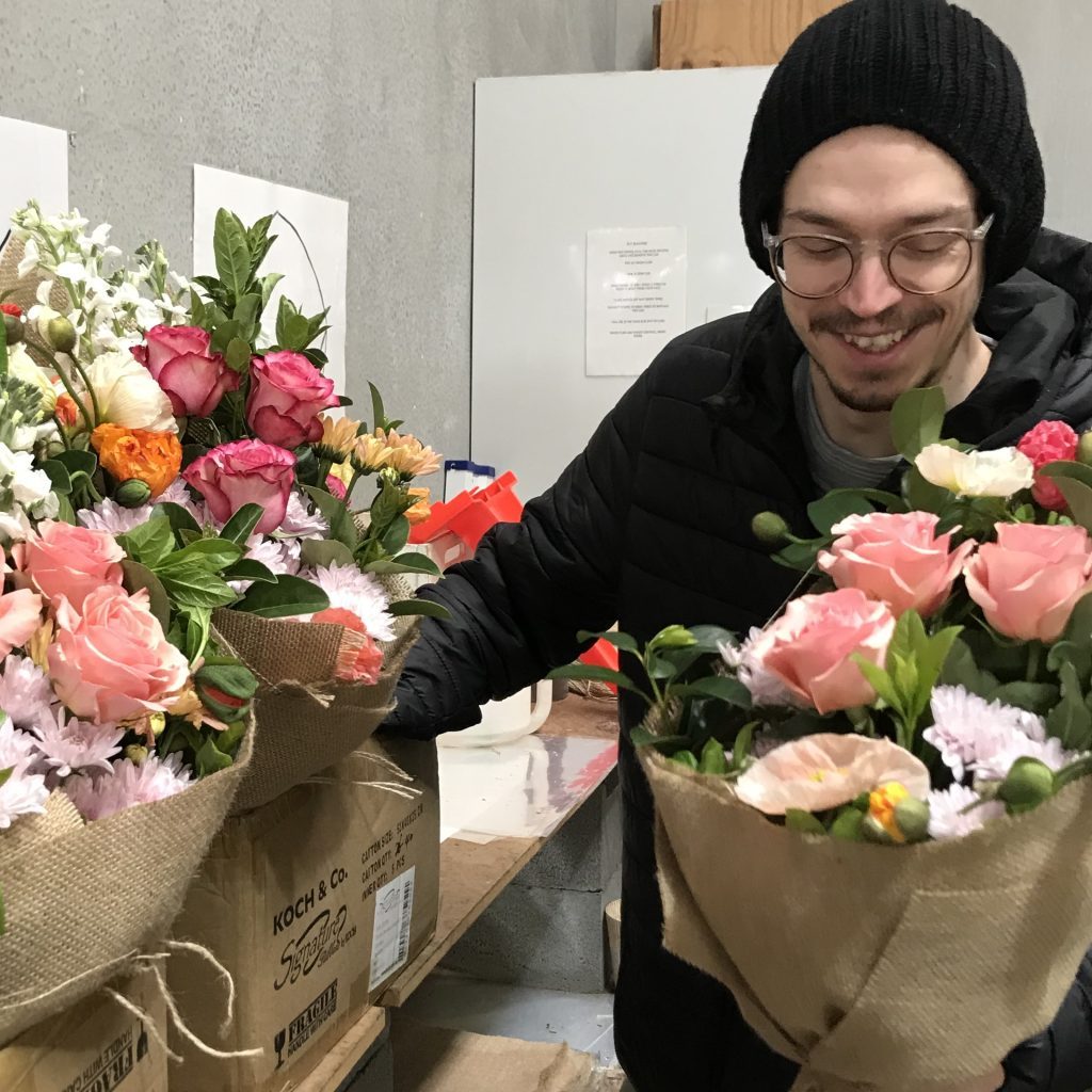 Man holding flowers at Little Flowers Sydney HQ
