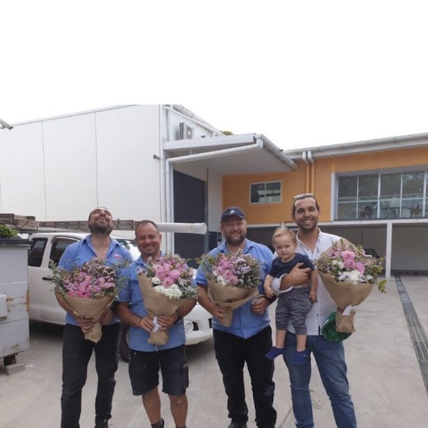 Men holding flower bouquets in Sydney