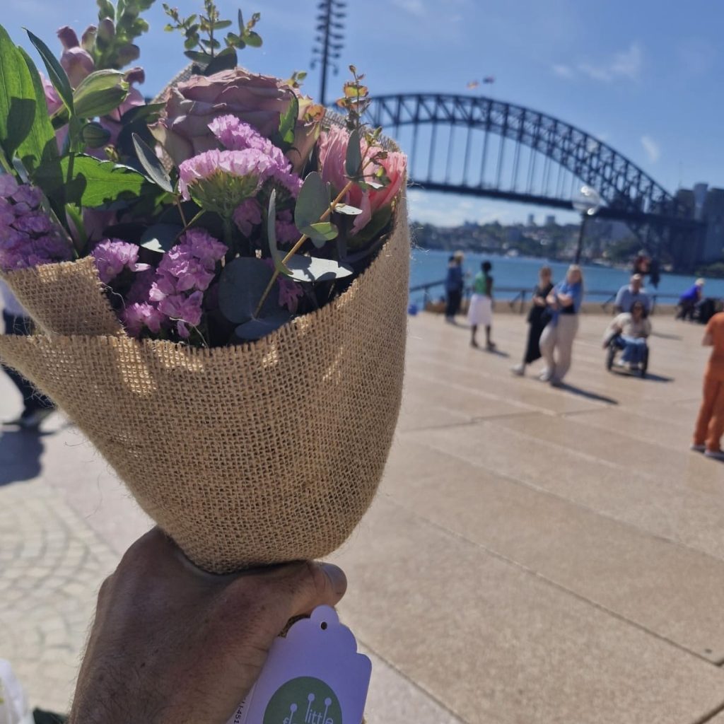 bouquet of flowers with Sydney Harbour Bridge in background during CBD delivery